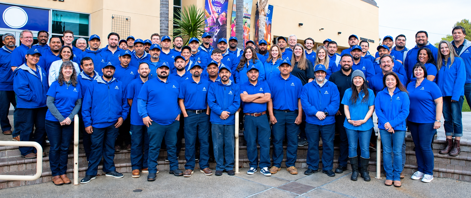 The Strategic Sanitation Services team together in their blue uniforms