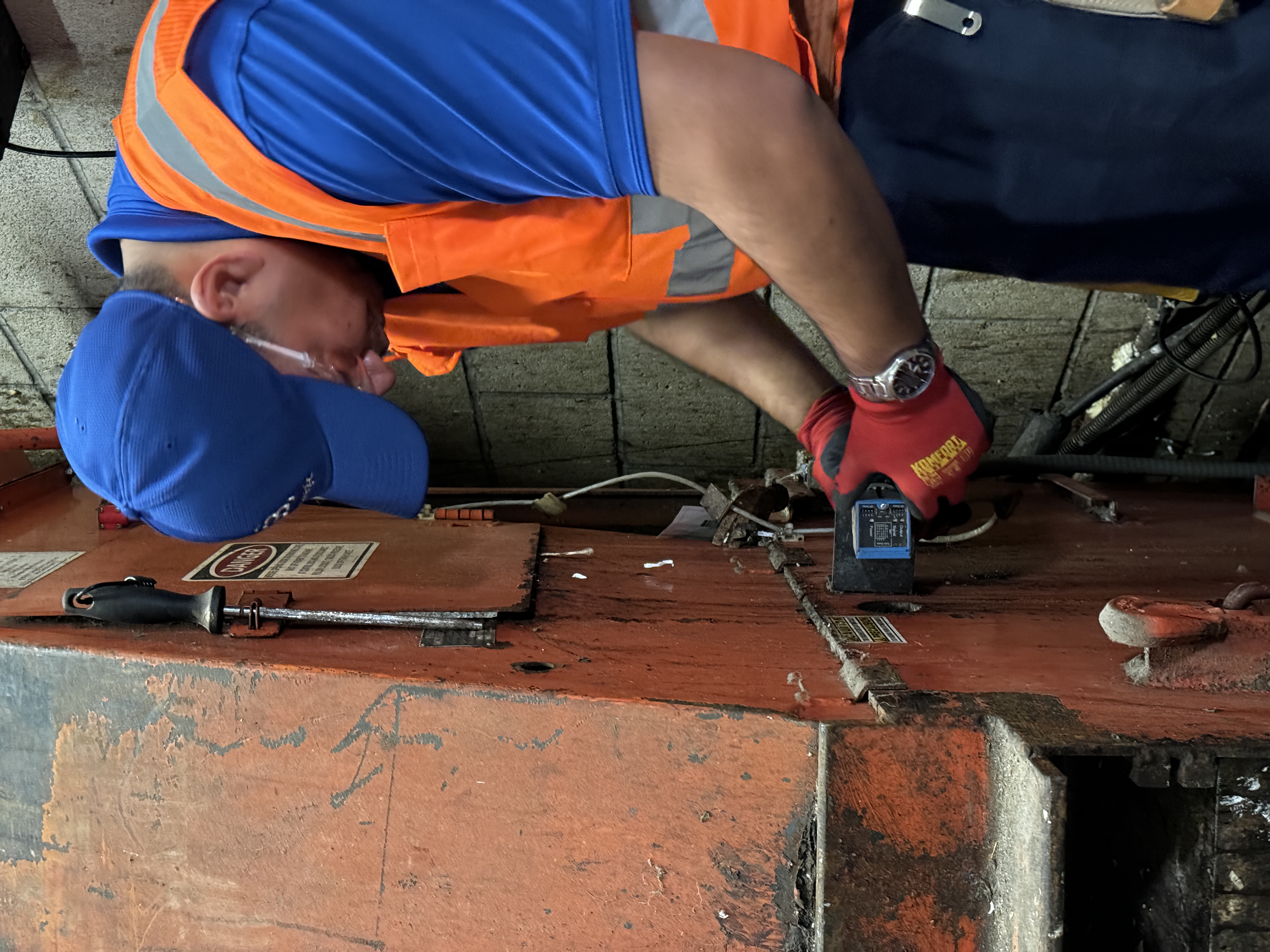 Strategic technician checking compactor equipment with a handheld instrument